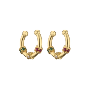 Macro shot of gold ear cuffs with colorful gemstone clusters and beaded metal details