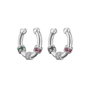Macro detail of silver bamboo-style ear cuffs with colorful micro-pave crystals