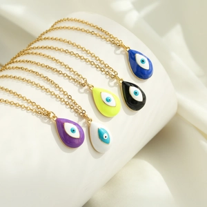 Five colorful evil eye teardrop necklaces with 18k gold plating on elegant display stand