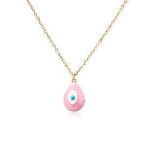 Detailed macro view of pink enamel evil eye water drop pendant on a gold O-chain necklace