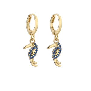 Macro detail of gold toucan earrings featuring blue micro-inlaid cubic zirconia stones