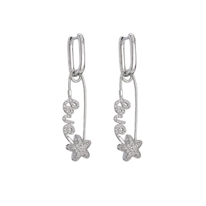 Detailed view of silver safety pin earrings with Love lettering and star pendant detail