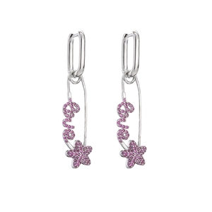 Detail of silver safety pin earrings with pink zircon pavé Love and star motifs