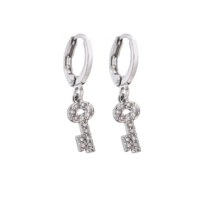 Macro detail of silver key drop earrings with micro-paved cubic zirconia stones