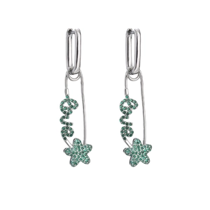 Macro detail of silver safety pin earrings with green crystals and star love charms