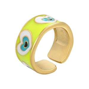 Detailed close-up of yellow enamel heart evil eye pattern on golden open ring band