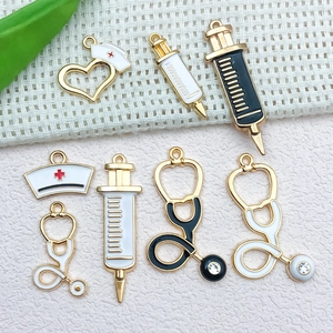 Close-up of medical-themed charms with stethoscope and syringe designs for DIY jewelry making