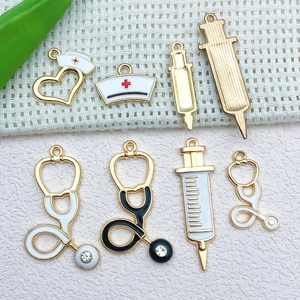 Detail shot of medical charms including enamel nurse hat and stethoscope for DIY jewelry