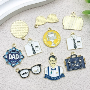 Detailed flat lay of Father's Day alloy enamel charms with briefcase and glasses motifs