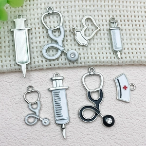 Medical charm set featuring stethoscope, syringe and nurse hat in silver alloy
