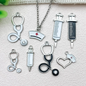 Detail of medical themed charms with stethoscopes, syringes, and nurse hats for DIY making