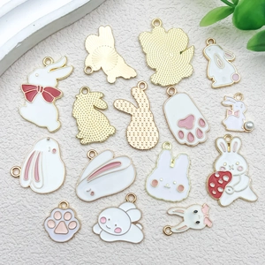 Detail of assorted DIY cartoon rabbit enamel pendants with gold alloy loops for jewelry making