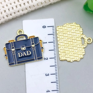 Macro view of blue enamel briefcase pendant with DAD lettering and 2.5cm scale ruler