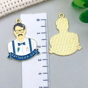 Detail of alloy Father's Day pendant showing enamel suit design and gold back texture