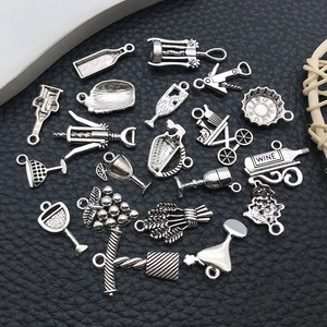 Detailed macro view of vintage silver wine-themed alloy charms for DIY jewelry making