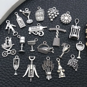 Detailed macro view of vintage silver wine-themed alloy charms on black leather
