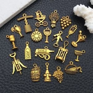 Close-up of vintage gold alloy wine charms set featuring bottles and wine cups