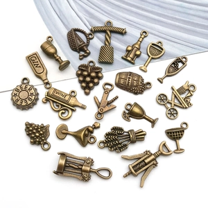 Macro detail of vintage bronze wine themed alloy charms for DIY jewelry and crafts