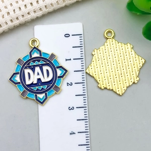 Star-shaped DAD enamel pendant charm with blue accents and gold-plated textured back