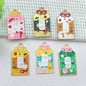 Japanese lucky charm enamel pendants featuring Maneki Neko and cherry blossom designs