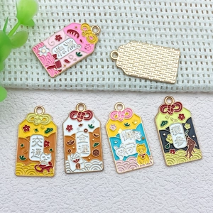 Macro view of five colorful Japanese Omamori alloy pendants for DIY jewelry making