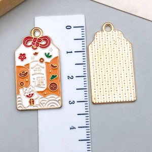 Macro detail of alloy enamel lucky charm pendant with scale showing 3.5cm size