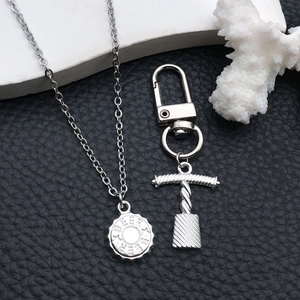 Detailed close-up of silver alloy beer cap pendant and cross bottle opener keychain accessories