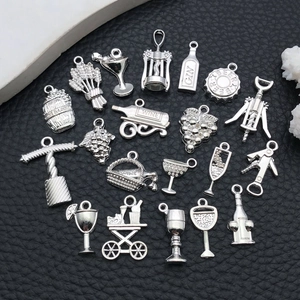 Macro detail of silver vintage wine themed alloy charms including bottles and corkscrews