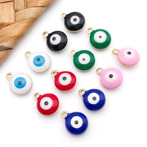 Macro shot of colorful round Evil Eye pendants with gold-plated rings for jewelry making