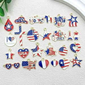 Flat lay of diverse American flag themed enamel charms in red white and blue patterns