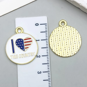 Macro detail of a 20mm round enamel American flag pendant with its textured gold back