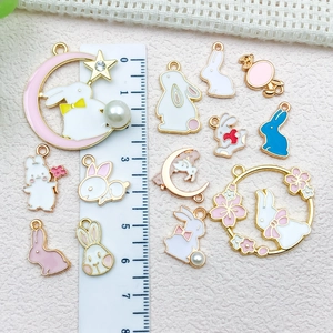Cartoon rabbit and flower wreath alloy charms with size reference on pink background