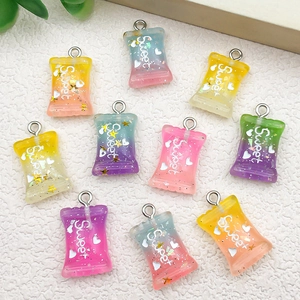 Macro detail of colorful resin candy charms with Sweet text for DIY jewelry making
