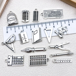 Vintage silver school stationery alloy charms set featuring ruler and backpack pendants