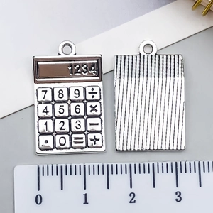 Macro shot of silver alloy calculator charm detail for DIY necklaces or bracelets