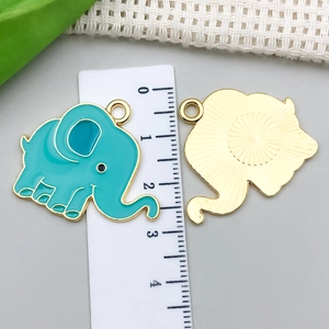 Blue enamel elephant charm pendant with gold plating and sunburst textured back