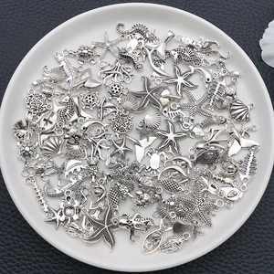 Macro shot of vintage silver sea star and seahorse pendants for DIY jewelry making