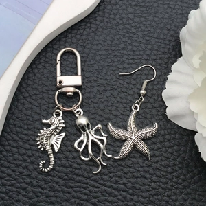 Detail of silver alloy marine charms featuring seahorse, octopus, and starfish pendants