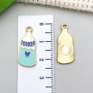 Blue and mint baby bottle charm with heart pattern and golden back for DIY jewelry