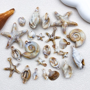 Detailed view of beige acrylic seashell and starfish charms for DIY jewelry making