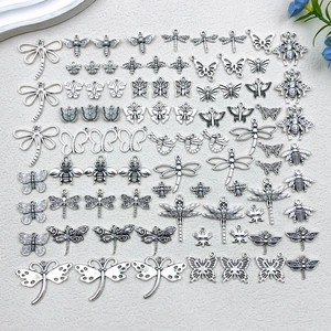 Detailed macro view of vintage silver insect pendants for DIY jewelry crafting