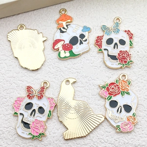 Detailed view of Halloween raven skull alloy charms with colorful drip oil floral designs