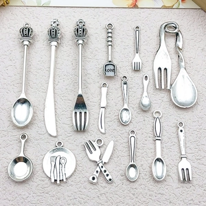 Detailed macro view of vintage silver cutlery pendants for DIY jewelry making