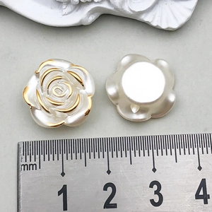 Detailed macro view of 20mm pearl white acrylic rose buttons with elegant gold edges