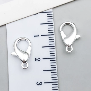 Silver metal lobster clasps for DIY jewelry making measured with a 12mm ruler scale