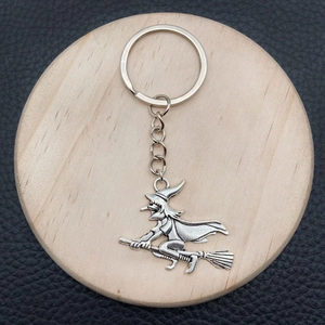 Silver metal witch riding a broom keychain accessory for Halloween jewelry decorations