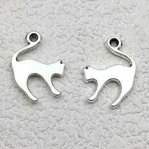 Detail of silver cat-shaped metal charms for DIY jewelry making and necklaces