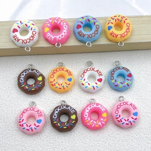 Detailed view of assorted resin donut pendants with silver rings for jewelry making