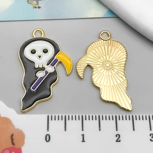 Detailed macro view of a Grim Reaper enamel charm with golden alloy base for DIY jewelry