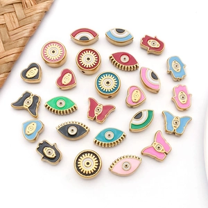 Colorful enamel evil eye and hamsa hand charms in gold plating for DIY jewelry